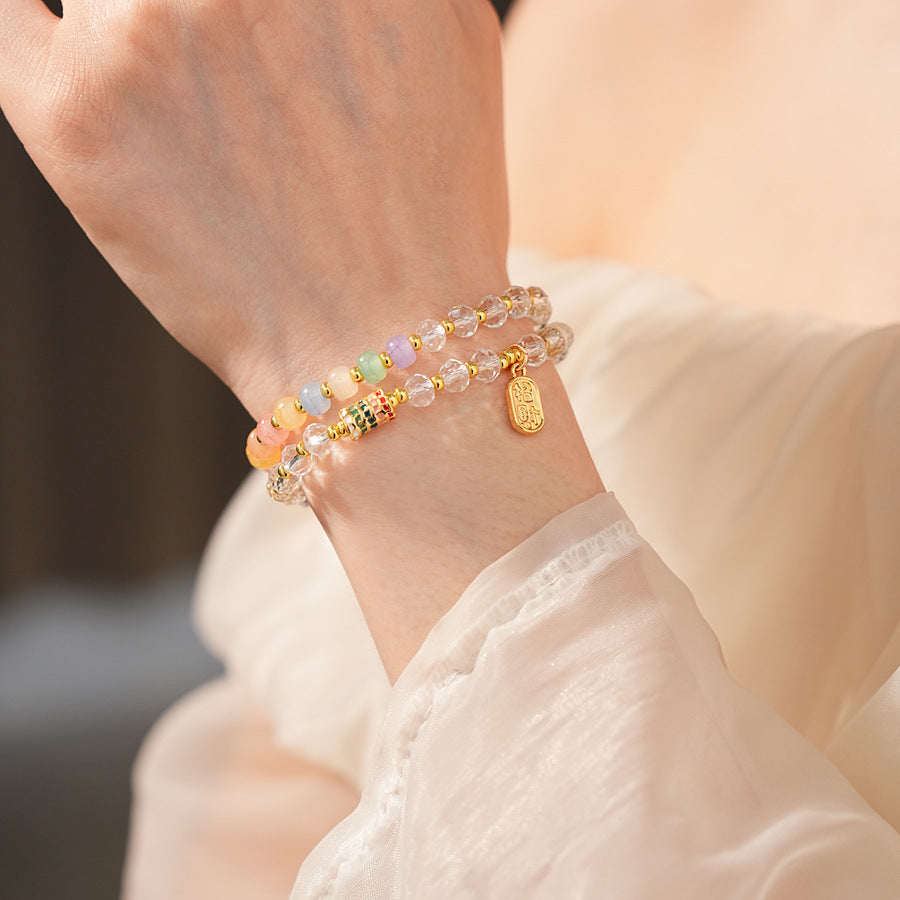 Double-layer dopamine crystal bracelet with clear crystals and colorful stone beads on green velvet background