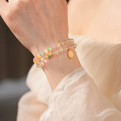 Double-layer dopamine crystal bracelet with clear crystals and colorful stone beads on green velvet background