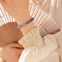 Natural blue crystal bracelet featuring a red flower bead centerpiece — Azure Dawn Crystal Bracelet by Glazenya.