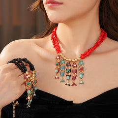 Statement necklace with articulated fishbone fringe, gold beads, and red or black chip strands — Kaleido Fishbone Fringe Necklace.