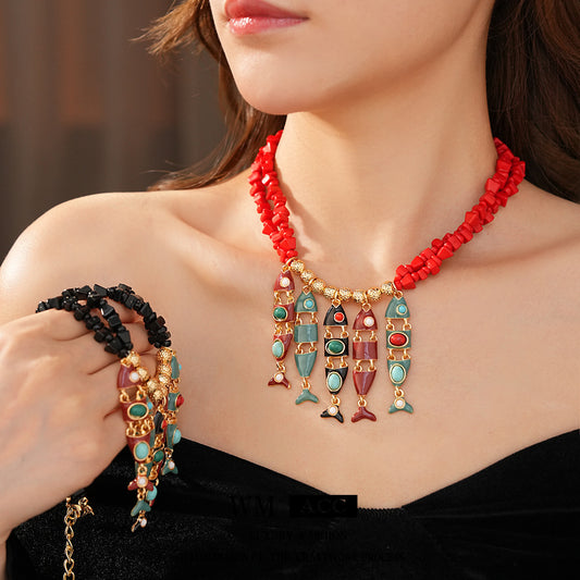 Statement necklace with articulated fishbone fringe, gold beads, and red or black chip strands — Kaleido Fishbone Fringe Necklace.