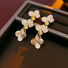 Golden Petal Elegance Set with necklace, bracelet, and earrings featuring golden floral petal details