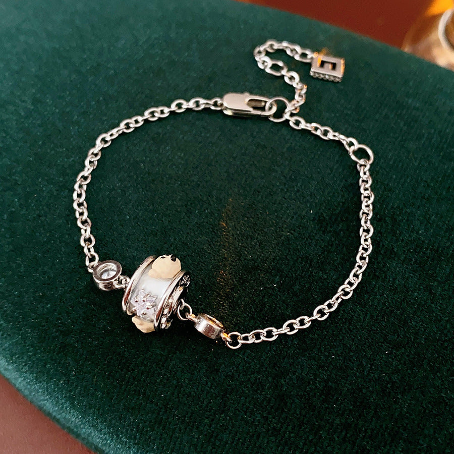 Ivory Glow Barrel Charm Collection — white enamel barrel-bead necklace, bracelet and right-ear cuff on black jewelry box, silver-tone chains with zircon details