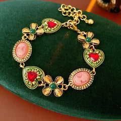 Royal Garden Cameo Set with gold-tone floral links, pink cameo ovals, green enamel hearts, and red stones