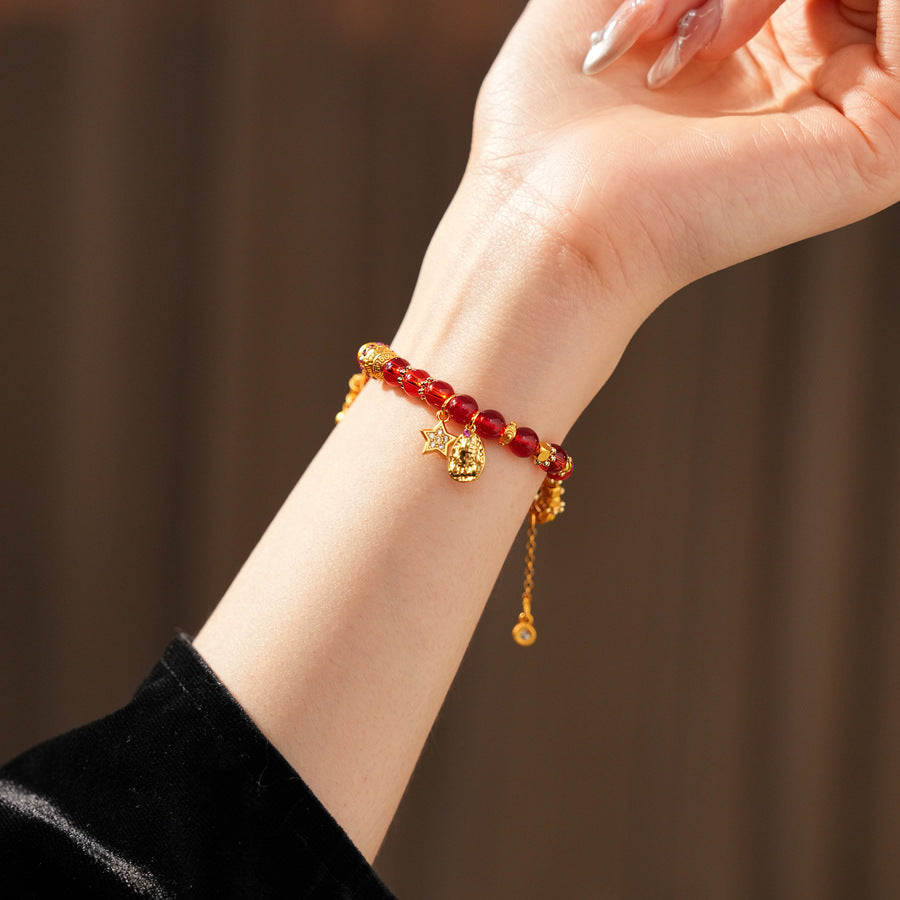 Aurora Red Prosperity Bracelet with red crystal beads and golden fortune charms—star, coin, and drum—on adjustable chain – Glazenya