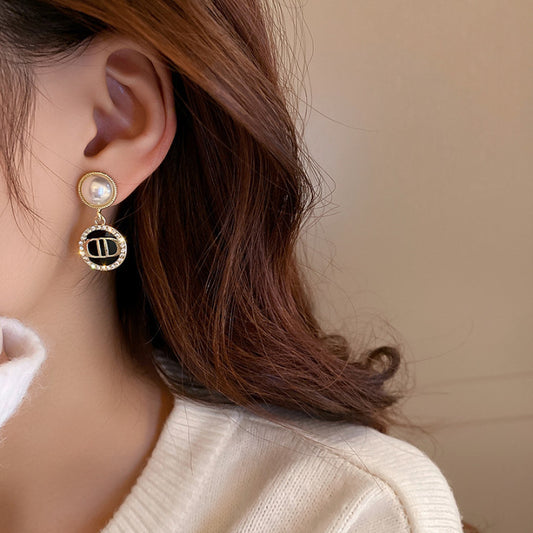Camellia & Bow Earring Collection with black camellia, bow, pearl, and geometric designs – chic light luxury retro jewelry
