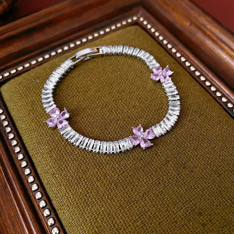 Petal Sparkle Tennis Bracelet lineup in gold and silver with pink and blue accents – baguette zircon floral design