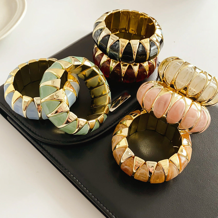 Gold-tone segmented bangle with marbled acrylic dome tiles — Gilded Capsule Resin Bangle.