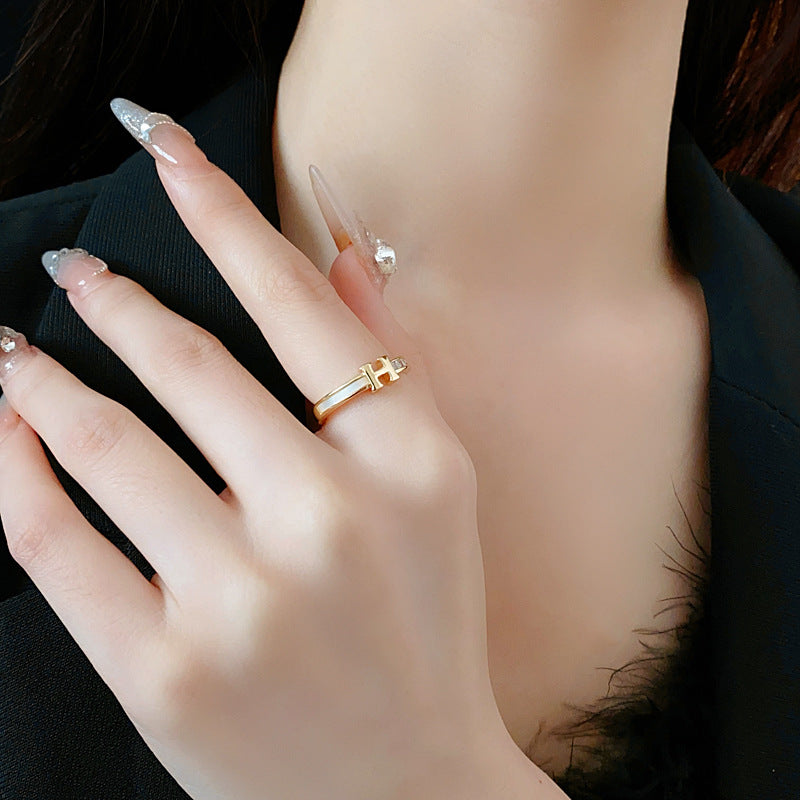 Gold-tone open ring with initial bridge and channel-set pavé cubic zirconia — Lumière Initial Pavé Open Ring.
