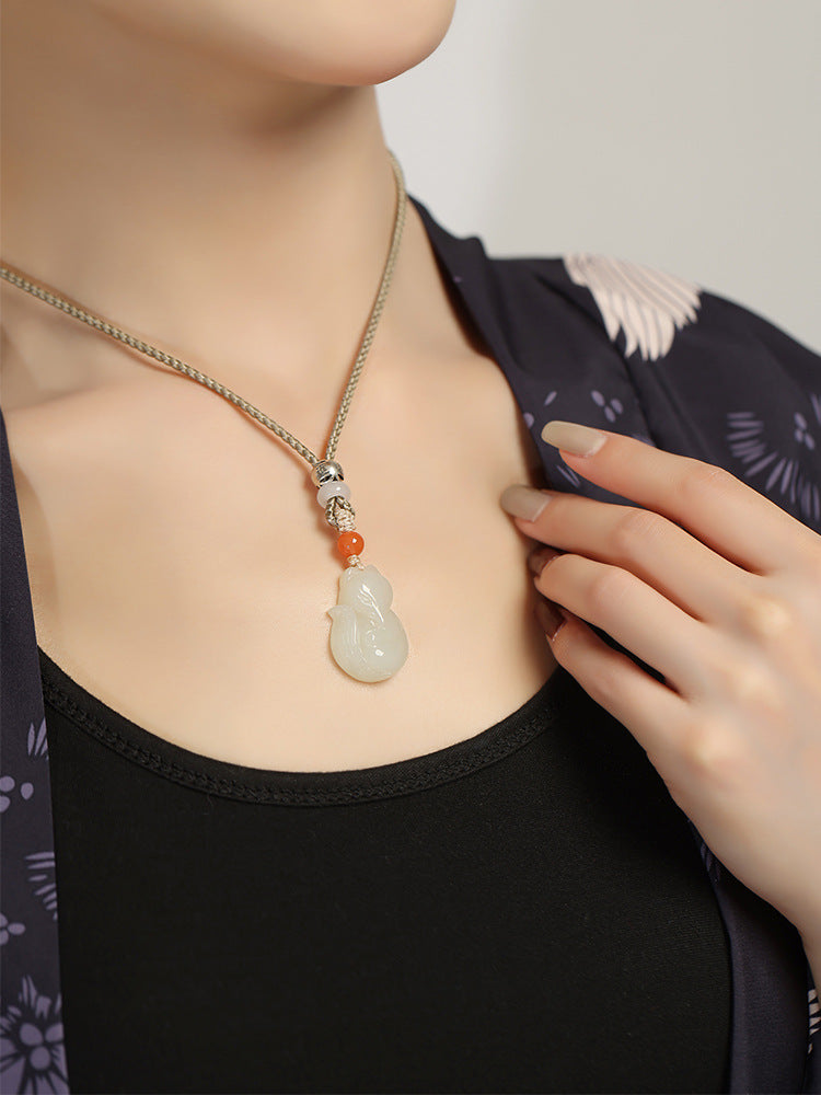 Hand-carved Hetian jade fox pendant on braided cord — Peach Blossom Hetian Jade Fox Pendant