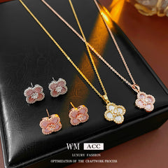 Clover jewelry collection — earrings and necklace displayed together