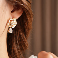 Gold-tone rose stud earrings with ivory and black enamel petals plus teardrop zircon dangles — Gilded Rose Teardrop Studs.