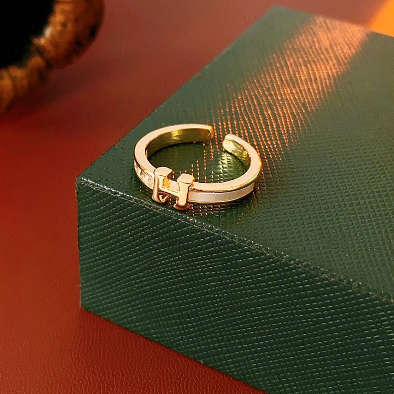 Gold-tone open ring with initial bridge and channel-set pavé cubic zirconia — Lumière Initial Pavé Open Ring.