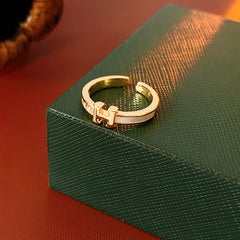 Gold-tone open ring with initial bridge and channel-set pavé cubic zirconia — Lumière Initial Pavé Open Ring.