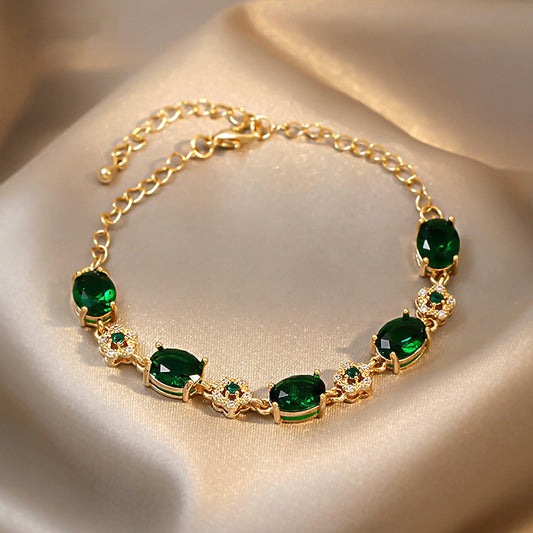 Gold-plated bracelet with emerald crystal centerpiece and zircon accents