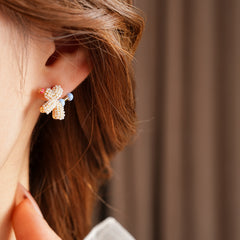 Balloon dog stud earrings crafted from imitation pearls with blue bead details — Playful Poodle Pearl Studs.