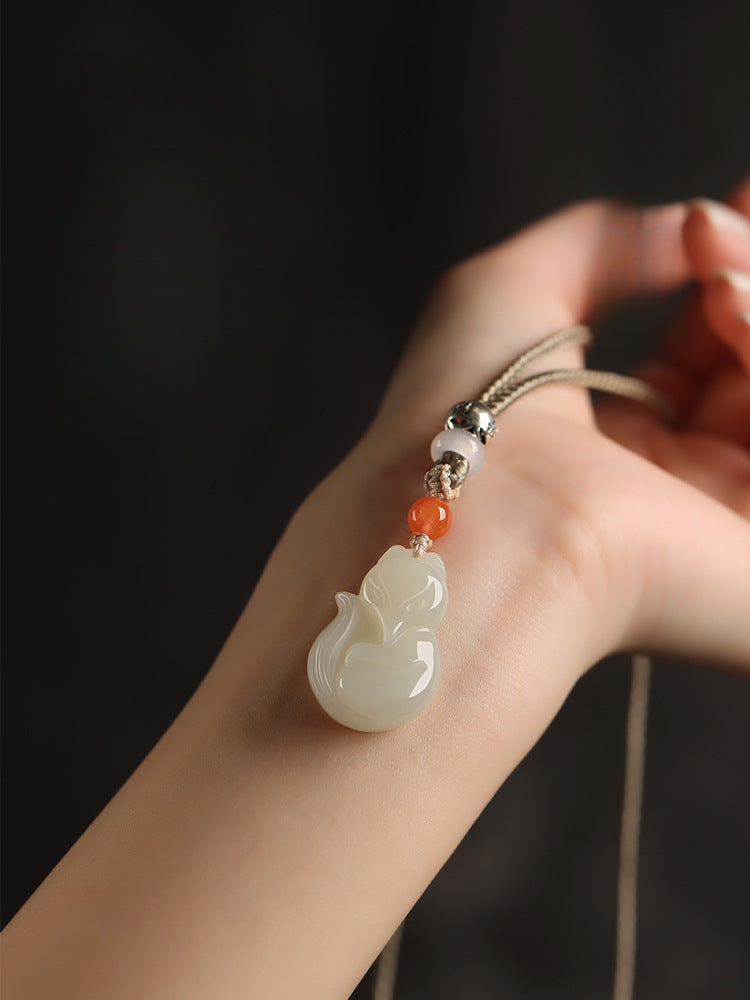 Hand-carved Hetian jade fox pendant on braided cord — Peach Blossom Hetian Jade Fox Pendant