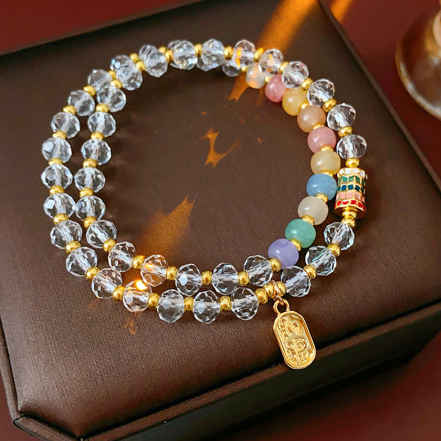 Double-layer dopamine crystal bracelet with clear crystals and colorful stone beads on green velvet background