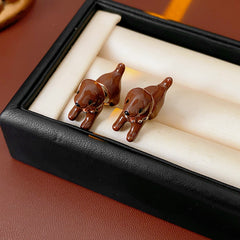 Glossy 3D puppy stud earrings in silver, pink, and coffee on post backs — Playful Pup Stud Earrings.