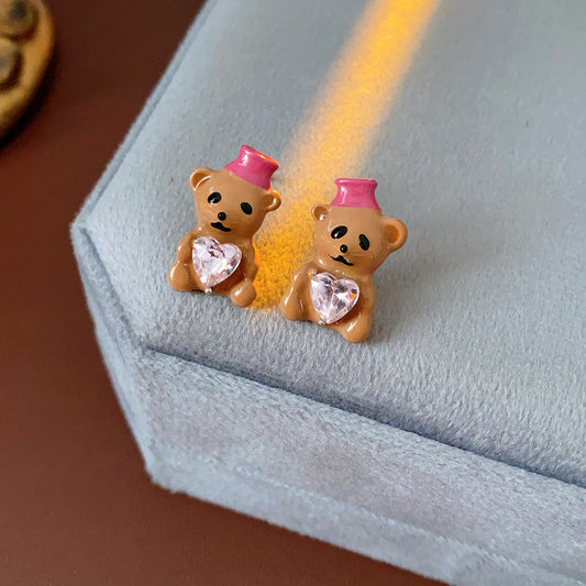 Silver-tone necklace with coffee teddy pendant and pink hat, matching teddy stud earrings with heart crystal — Sweetheart Teddy Crystal Jewelry.