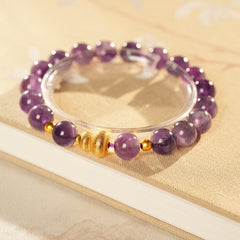 Natural amethyst beaded bangle with gold-tone accents and a lucky charm (Floral or Gourd) — Violet Fortune Amethyst Bangle.