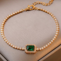 Gold-plated bracelet with emerald crystal centerpiece and zircon accents