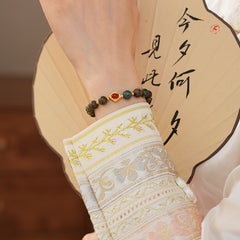 <div class="gz-desc">
  <p>Earthy and refined <strong>natural stone bracelet</strong> combining lush <strong>green ghost</strong> beads with smooth <strong>agate</strong>, accented by a warm red centerpiece and gold-tone spacers for a subtle touch of luxury.</p>

  <h3>Design Story</h3>
  <p>The <strong>Forest Ember Agate Bracelet</strong> evokes the calm of an ancient forest lit by a single ember. Mossy green tones bring grounding energy, while the red accent adds a gentle spark—balance between serenity an