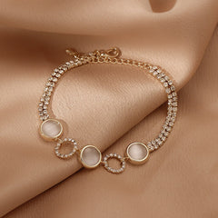 Gold-plated bracelet collection with pearls, cat’s eye stones, and floral motifs
