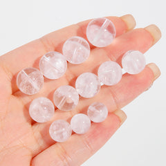 Clear quartz crystal rounds with white phantom inclusions and faint rainbow flash — Frostbow Atrium (7–14 mm).