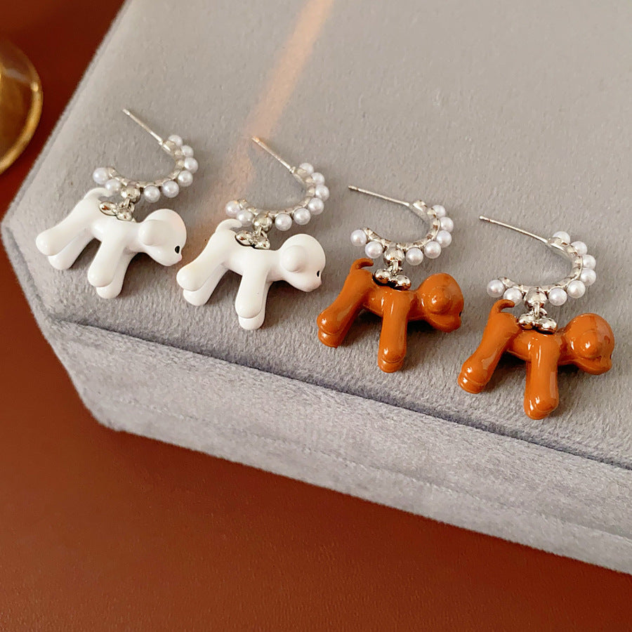 Pearl-adorned hoop earrings with dangling puppy charms in white and coffee — Pearl Pup Charm Hoops.