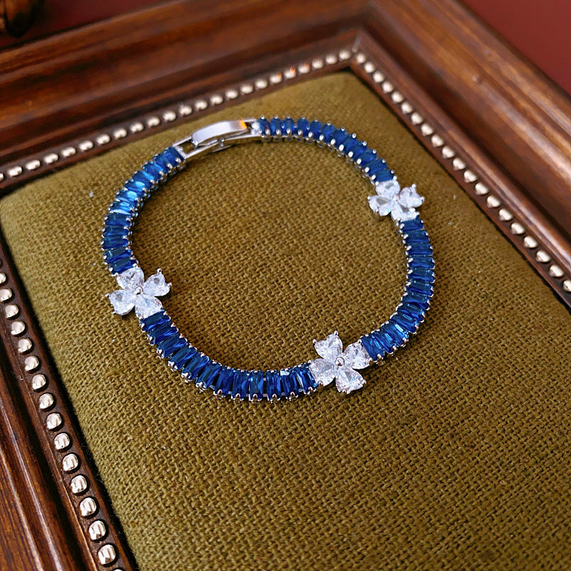 Petal Sparkle Tennis Bracelet lineup in gold and silver with pink and blue accents – baguette zircon floral design