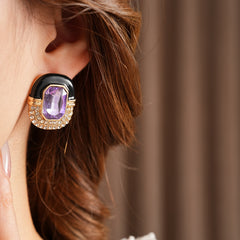 Black enamel stud earrings with amethyst-tone crystal and rhinestone frame — Midnight Amethyst Radiance Earrings.