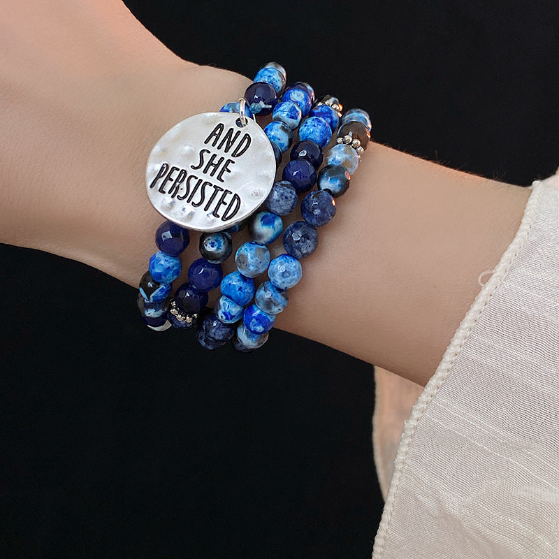 Multi-wrap blue agate bracelet with “AND SHE PERSISTED” charm — Ocean Resolve Bracelet by Glazenya.