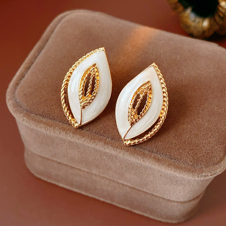 Leaf-shaped stud earrings with gold outline and white enamel – Golden Leaf Elegance Stud Earrings.