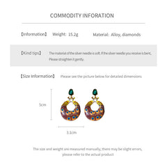 Statement earrings with peacock feather hoop design and emerald stud – Peacock Glory Statement Earrings.