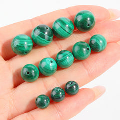 Malachite round beads with green banded “peacock” patterns, polished, assorted 4–12 mm — Peacock Veins.