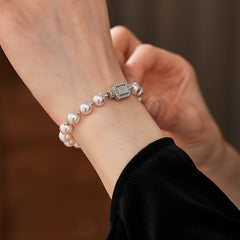 Deco Halo Pearl Bracelet featuring luminous pearls and a pavé-framed rectangular mother-of-pearl charm.