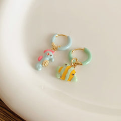 Pastel enamel huggie earrings with mismatched seahorse and striped fish charms — Seafoam Mismatch Ocean Charm Huggies.