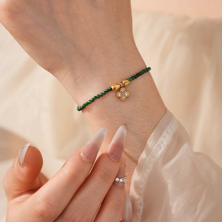 Two variant options of a malachite charm bracelet: beaded green strand with a crystal bloom charm, and a gold-tone chain with malachite accents and a heart pendant — Malachite Charm Bracelet (Variants).