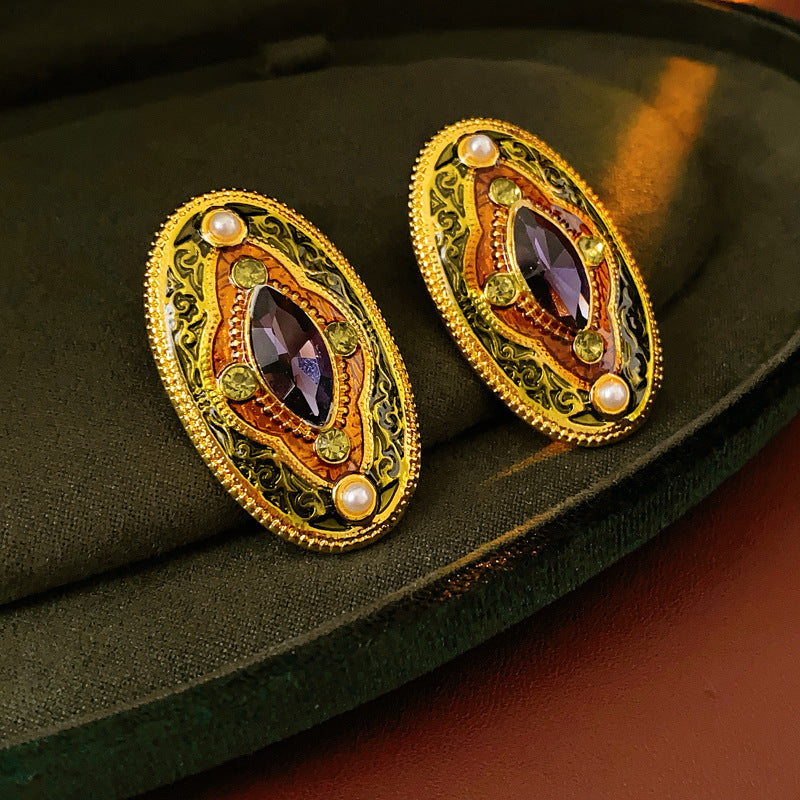 Antique-gold oval earrings with marquise purple crystal, olive rhinestones, and pearl accents — Byzantine Marquise Pearl Oval Earrings.