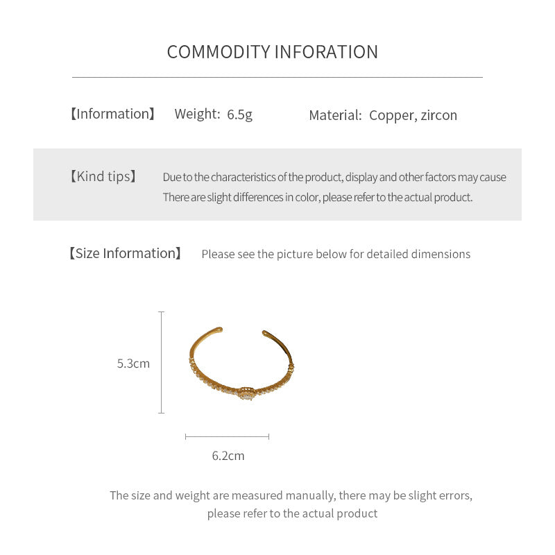 Elegant open bangle in gold with sparkling zircon stones and a marquise centerpiece, light-luxury adjustable bracelet.