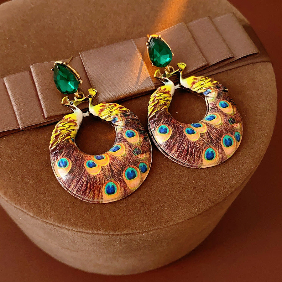 Statement earrings with peacock feather hoop design and emerald stud – Peacock Glory Statement Earrings.