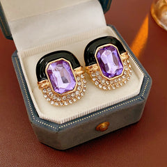 Black enamel stud earrings with amethyst-tone crystal and rhinestone frame — Midnight Amethyst Radiance Earrings.