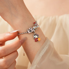 Kawaii Charm Story Bracelet with cartoon cat, burger, camera, and bell charms on silver-tone bead chain