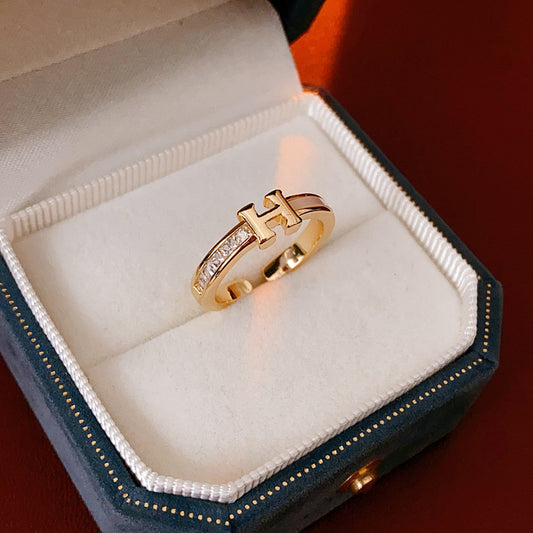 Gold-tone open ring with initial bridge and channel-set pavé cubic zirconia — Lumière Initial Pavé Open Ring.