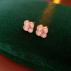 Clover jewelry collection — earrings and necklace displayed together