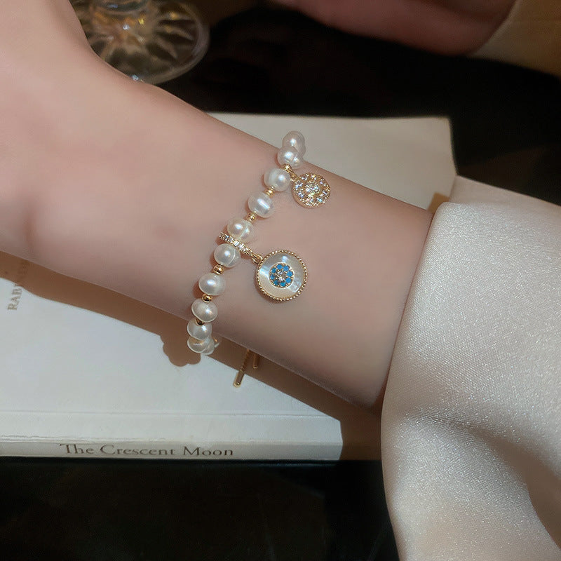 Gold-plated bracelet collection with pearls, cat’s eye stones, and floral motifs
