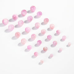 Pink-lilac kunzite round beads with silky glow, assorted 6–13 mm — Sakura Haze.