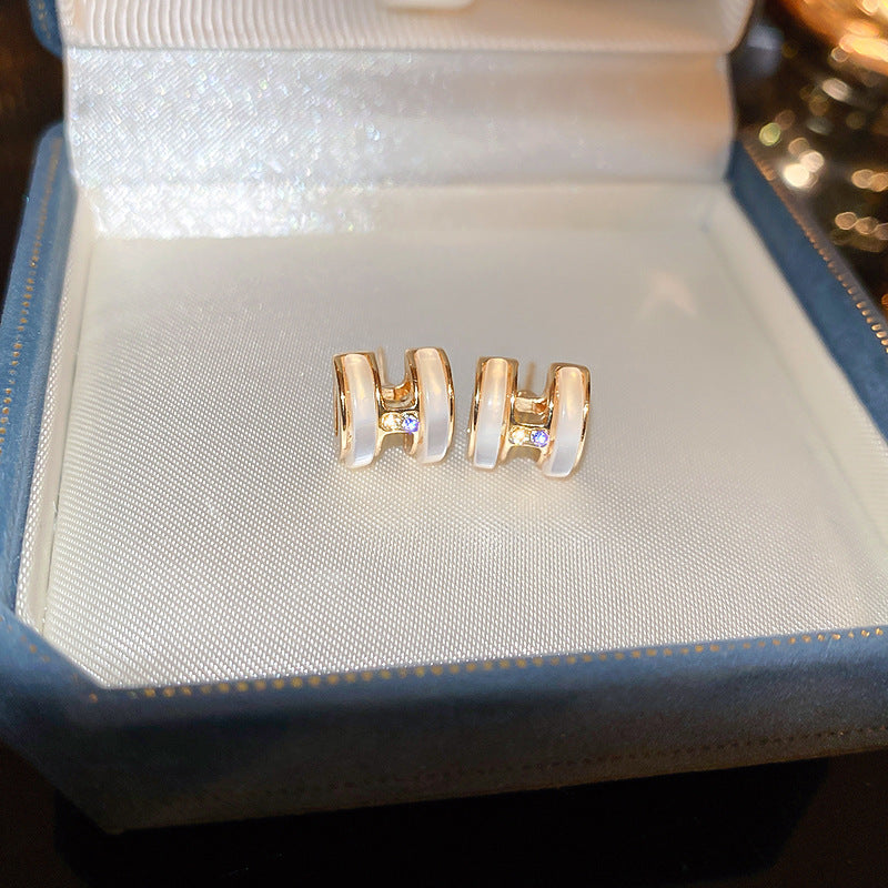 H initial jewelry series — necklace, ring, and earrings displayed individually