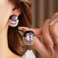 Black enamel stud earrings with amethyst-tone crystal and rhinestone frame — Midnight Amethyst Radiance Earrings.